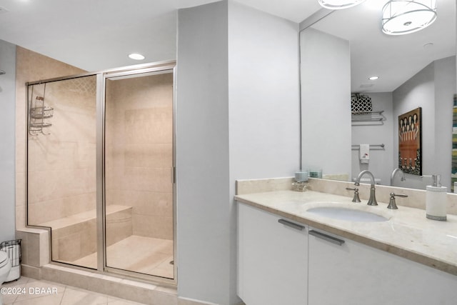 bathroom with vanity, tile patterned floors, and a shower with shower door