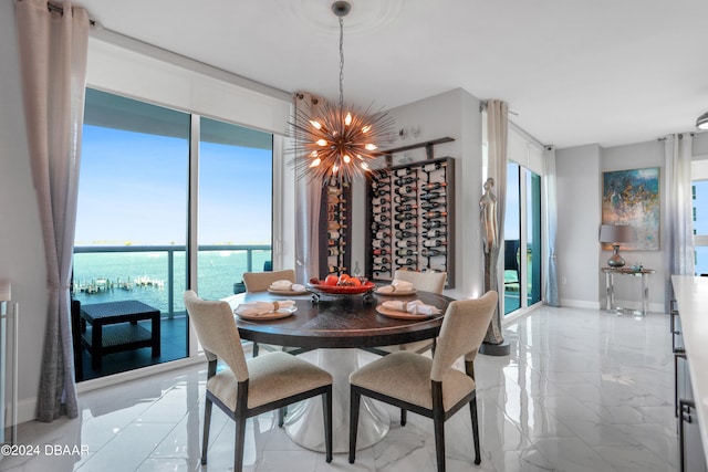 dining area with a chandelier and a water view