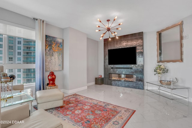 living room with a tile fireplace and a notable chandelier