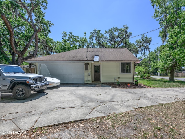 1635 Magnolia Ave, South Daytona, FL 32119 - ranch-style house featuring roof with shingles, a garage, and concrete driveway