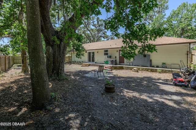 1635 Magnolia Ave, South Daytona, FL 32119 - rear view of property with cooling unit, roof with shingles, entry steps, a patio area, and fence