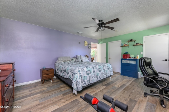1635 Magnolia Ave, South Daytona, FL 32119 - bedroom featuring visible vents, baseboards, a ceiling fan, a textured ceiling, and wood finished floors
