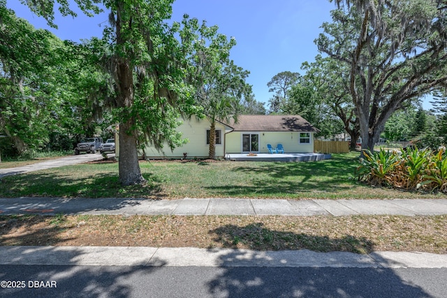 1635 Magnolia Ave, South Daytona, FL 32119 - view of front of house with a front yard and fence