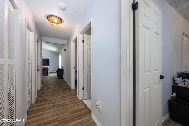 1635 Magnolia Ave, South Daytona, FL 32119 - hall featuring baseboards, light wood-type flooring, and a textured ceiling