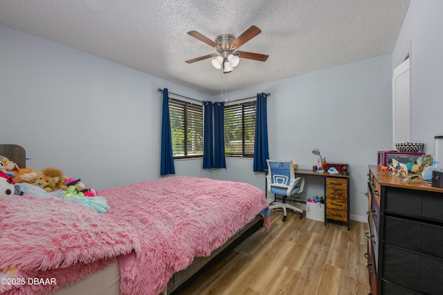 1635 Magnolia Ave, South Daytona, FL 32119 - bedroom featuring light wood-style flooring, a textured ceiling, and a ceiling fan