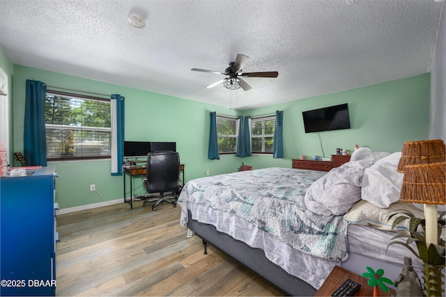 1635 Magnolia Ave, South Daytona, FL 32119 - bedroom featuring baseboards, multiple windows, wood finished floors, and a textured ceiling