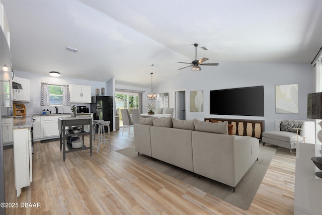 1635 Magnolia Ave, South Daytona, FL 32119 - living room featuring light wood-style floors, ceiling fan, lofted ceiling, and visible vents