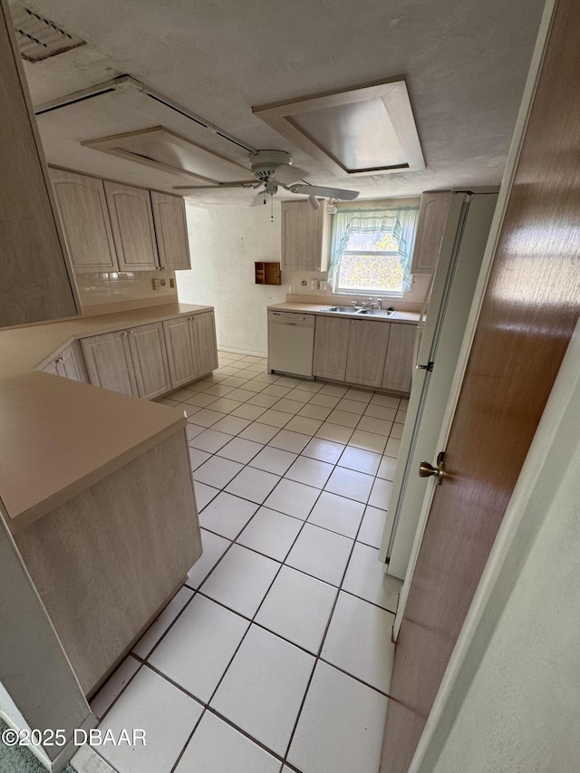 kitchen with light countertops, a ceiling fan, light brown cabinets, light tile patterned flooring, and dishwasher