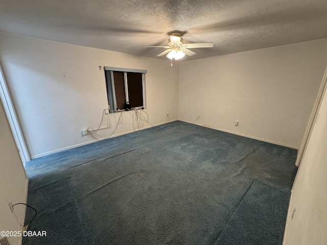 unfurnished room with ceiling fan, dark colored carpet, a textured ceiling, and baseboards