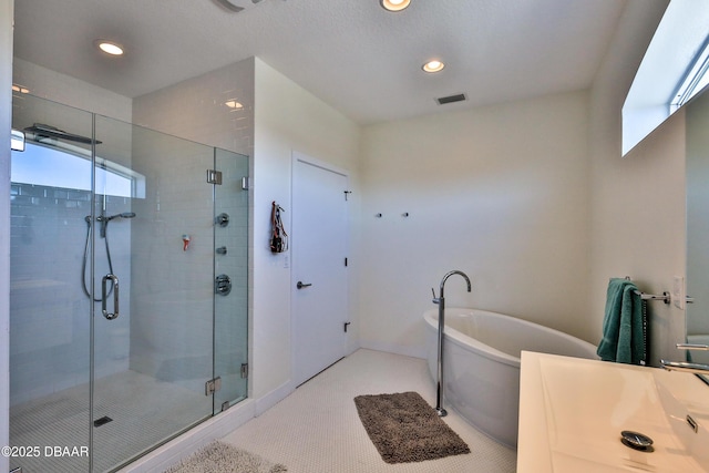 bathroom featuring tile patterned flooring and shower with separate bathtub