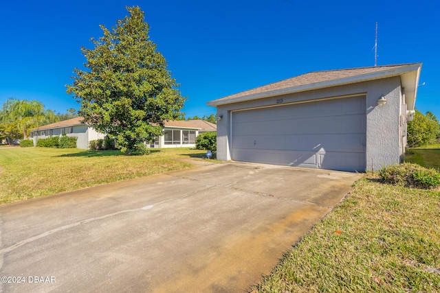 ranch-style house with a garage and a front lawn