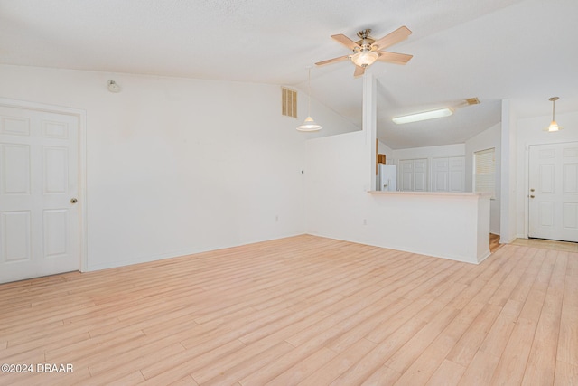 empty room with ceiling fan, light hardwood / wood-style floors, and lofted ceiling