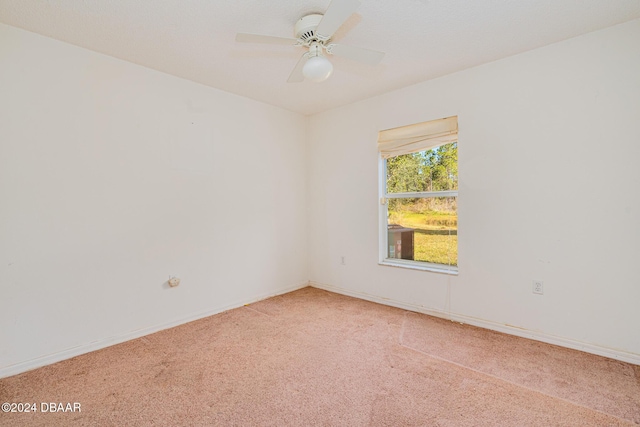 empty room featuring ceiling fan and carpet floors