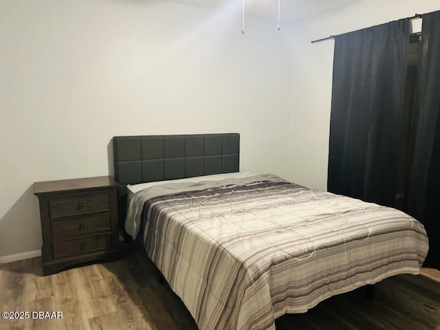 bedroom with hardwood / wood-style floors