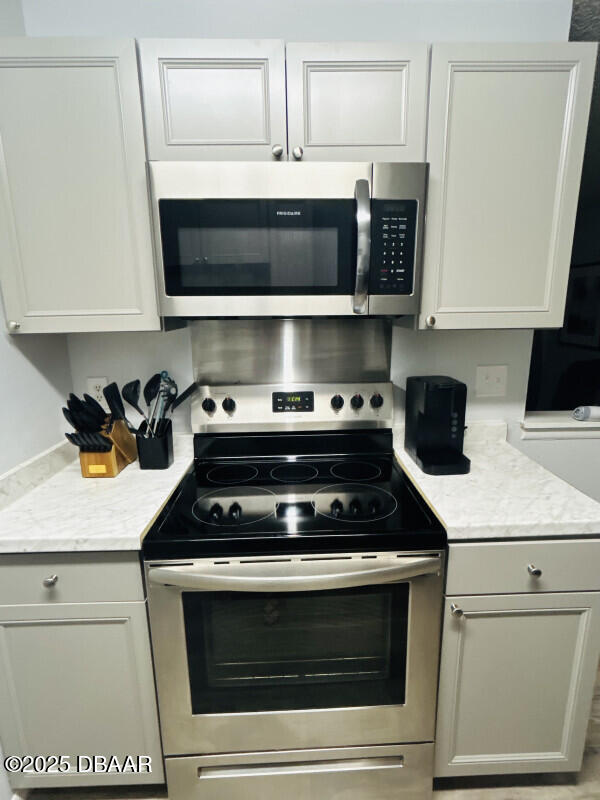 kitchen with white cabinetry and appliances with stainless steel finishes