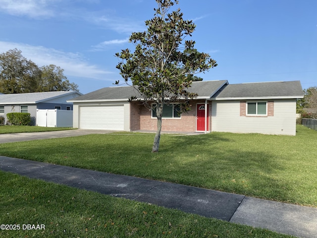 ranch-style home with concrete driveway, a front lawn, a garage, and fence