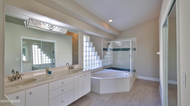 51 Bay Pointe Dr, Ormond Beach, FL 32174 - bathroom featuring vanity, vaulted ceiling, hardwood / wood-style floors, and plus walk in shower