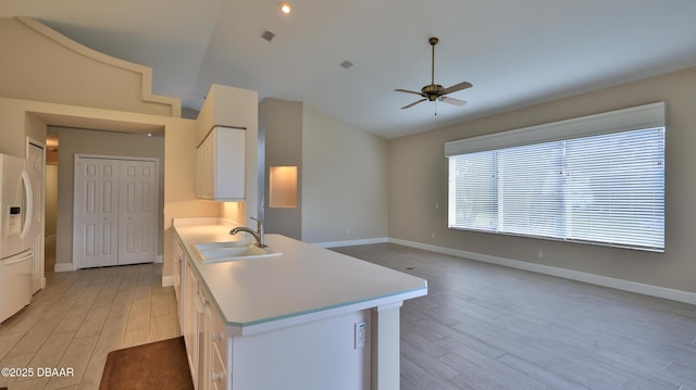 51 Bay Pointe Dr, Ormond Beach, FL 32174 - kitchen with sink, vaulted ceiling, light hardwood / wood-style flooring, ceiling fan, and white cabinets