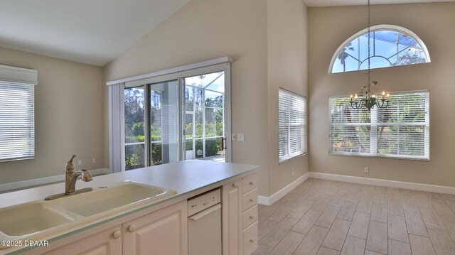 51 Bay Pointe Dr, Ormond Beach, FL 32174 - kitchen featuring decorative light fixtures, sink, light hardwood / wood-style floors, white dishwasher, and an inviting chandelier