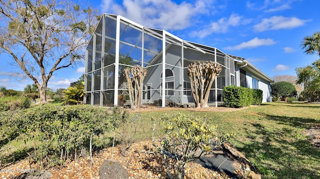 51 Bay Pointe Dr, Ormond Beach, FL 32174 - view of side of property featuring glass enclosure and a lawn