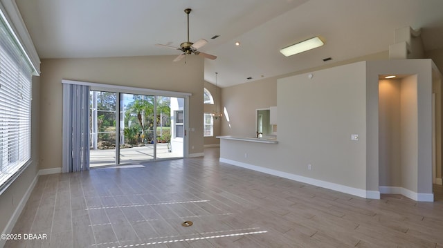 unfurnished living room with ceiling fan, high vaulted ceiling, and light hardwood / wood-style flooring