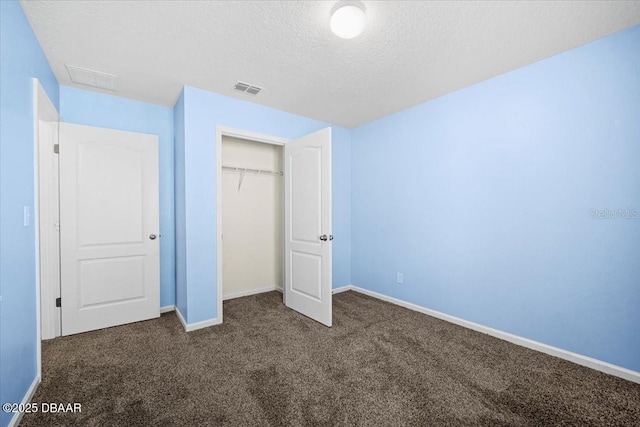 20 Sand Wedge Ln, Bunnell, FL 32110 - unfurnished bedroom featuring dark colored carpet, baseboards, a closet, and a textured ceiling