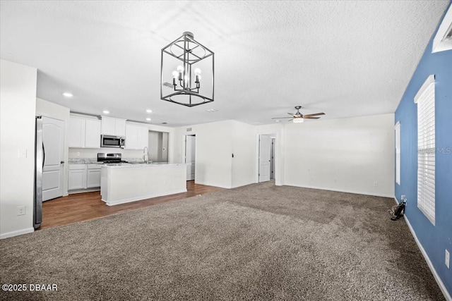 20 Sand Wedge Ln, Bunnell, FL 32110 - unfurnished living room featuring dark carpet, a ceiling fan, recessed lighting, a chandelier, and a sink