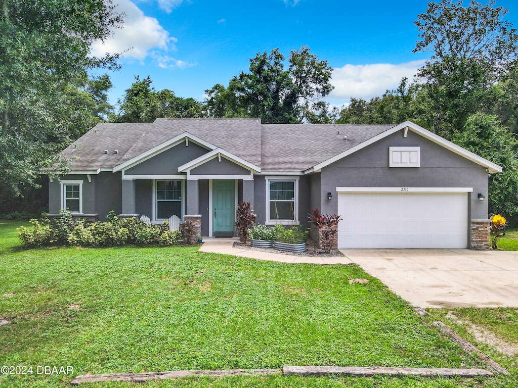 view of front of house with a front lawn and a garage