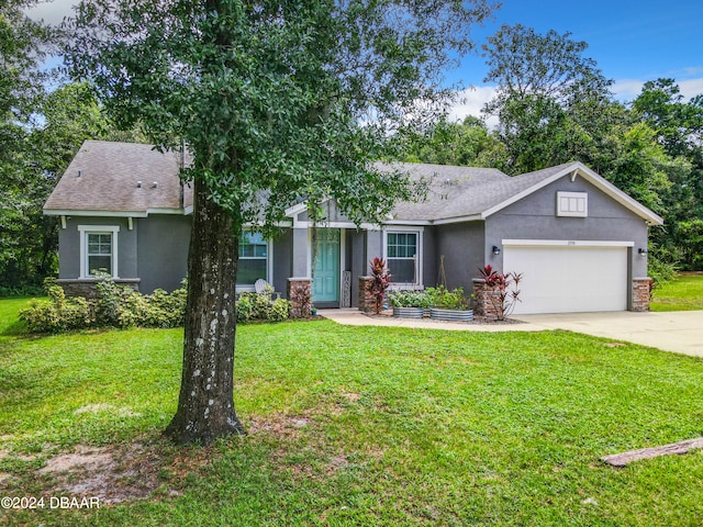 ranch-style home featuring a front lawn and a garage