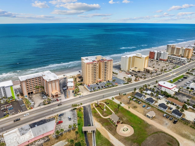 view of urban area with waterfront with a beach and apartment complex / building