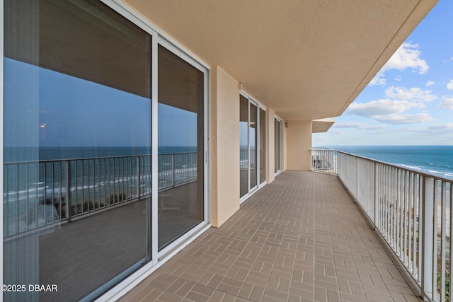 balcony featuring view of water and beach