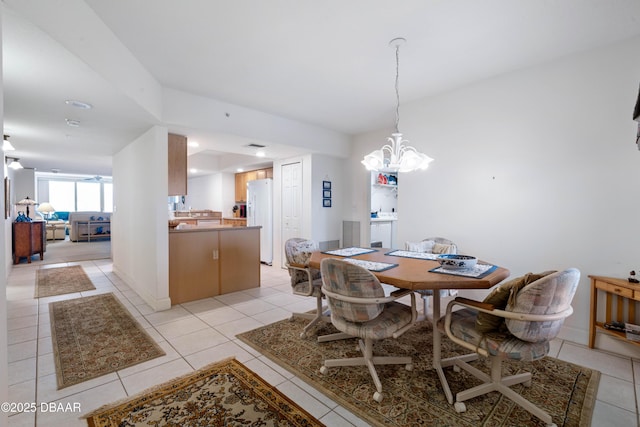 dining area featuring light tile patterned flooring and a chandelier