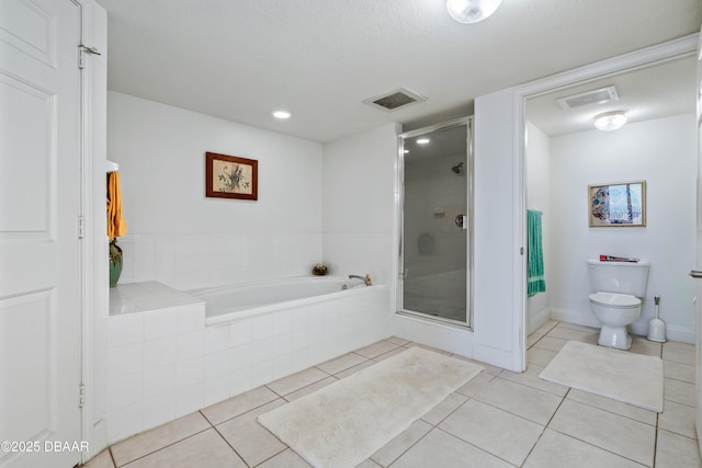 full bathroom with a stall shower, tile patterned floors, toilet, a bath, and recessed lighting