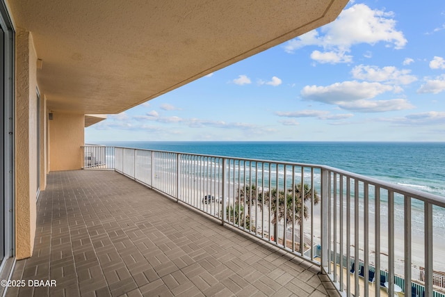 balcony featuring view of water and beach