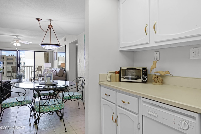 kitchen featuring light tile patterned floors, white dishwasher, hanging light fixtures, white cabinets, and ceiling fan