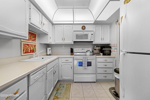 kitchen featuring white cabinetry, sink, white appliances, and light tile patterned floors