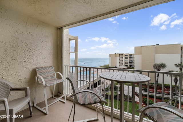 balcony with a beach view and a water view