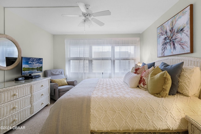 bedroom featuring ceiling fan and carpet