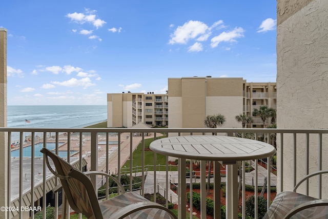 balcony with a beach view and a water view