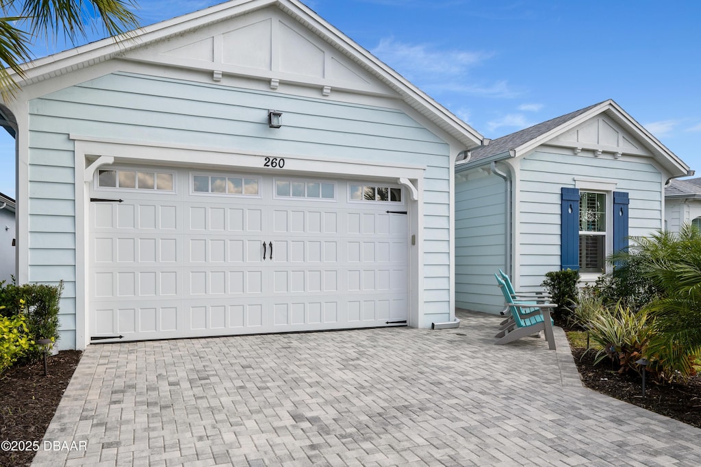 garage with decorative driveway