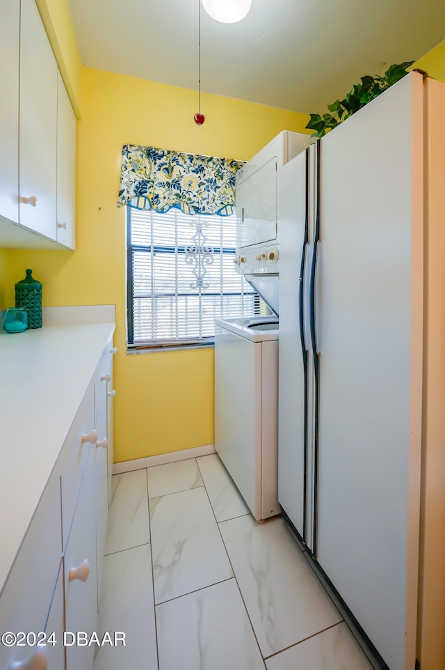 kitchen featuring white cabinets, washer / dryer, and white fridge