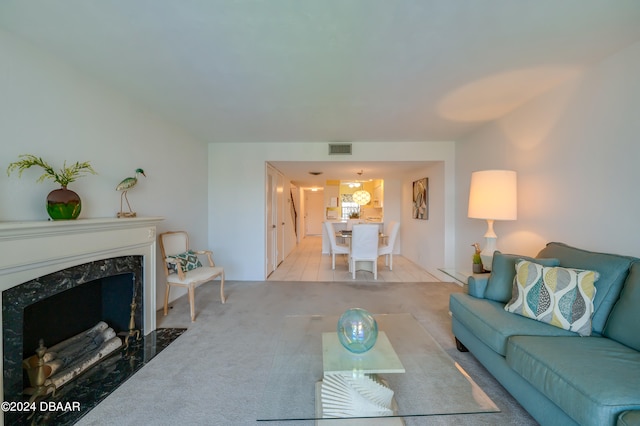 carpeted living room with a premium fireplace