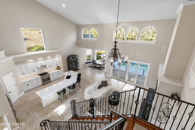 46 Audubon Ln, Flagler Beach, FL 32136 - living room featuring high vaulted ceiling and a chandelier
