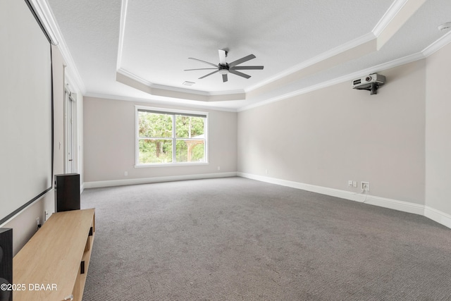 46 Audubon Ln, Flagler Beach, FL 32136 - carpeted empty room featuring a tray ceiling, crown molding, ceiling fan, baseboards, and a desk