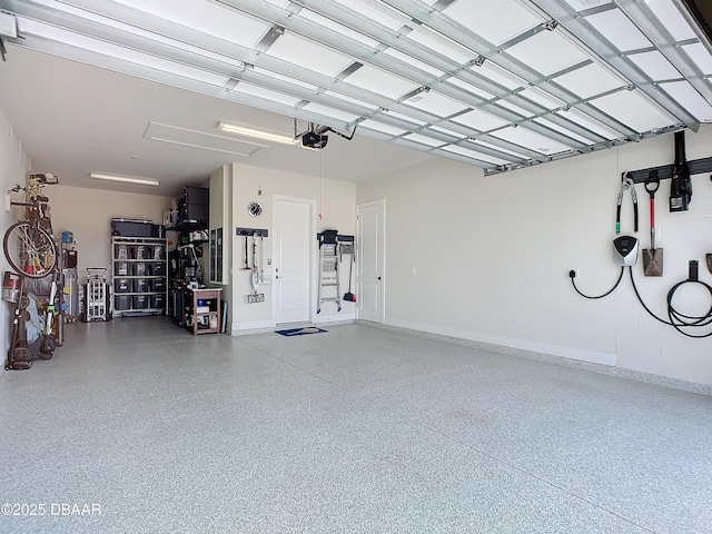 garage with a garage door opener and baseboards