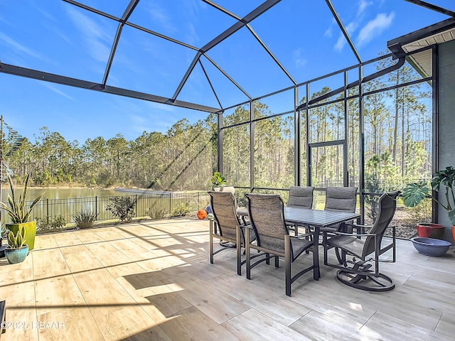 view of patio / terrace featuring glass enclosure and outdoor dining area