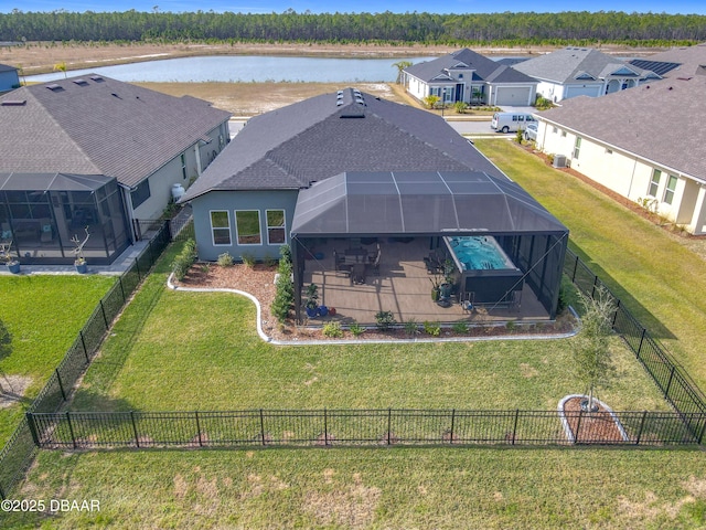 drone / aerial view with a water view and a residential view