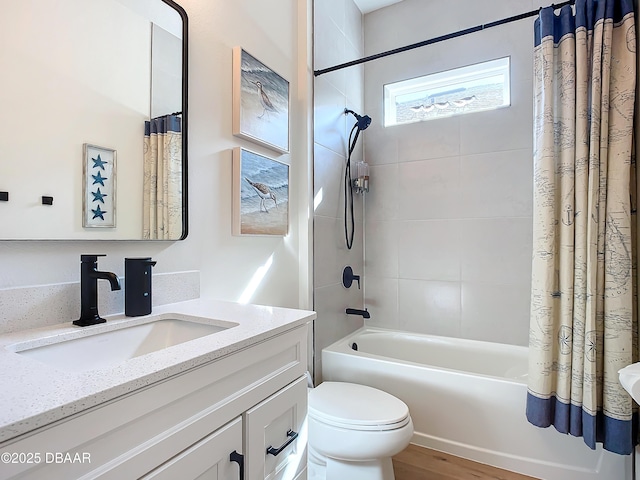 full bathroom featuring toilet, shower / bath combo, and vanity