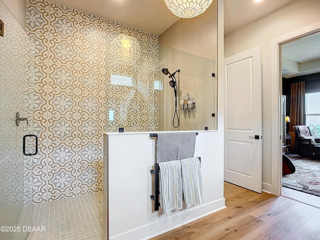 bathroom featuring wood finished floors and walk in shower