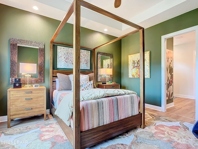 bedroom with baseboards, wood finished floors, and recessed lighting